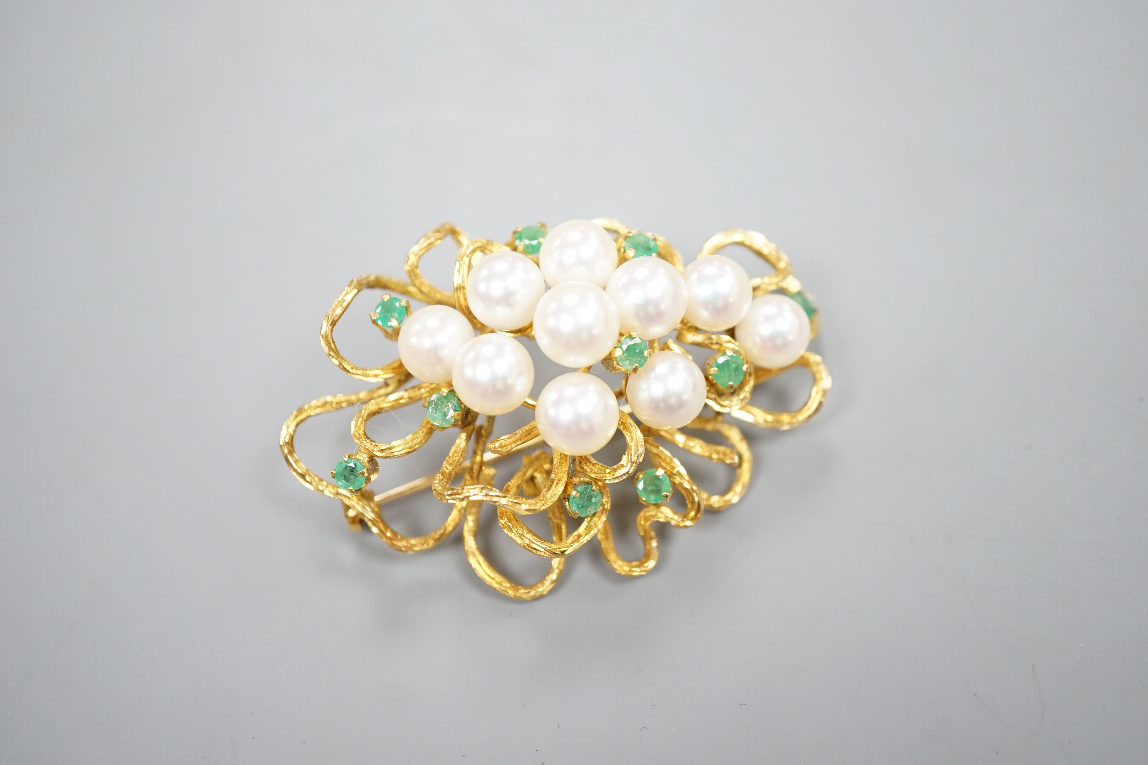 A modern 14k yellow metal, cultured pearl and emerald cluster set brooch, 54mm, gross weight 18.9 grams.